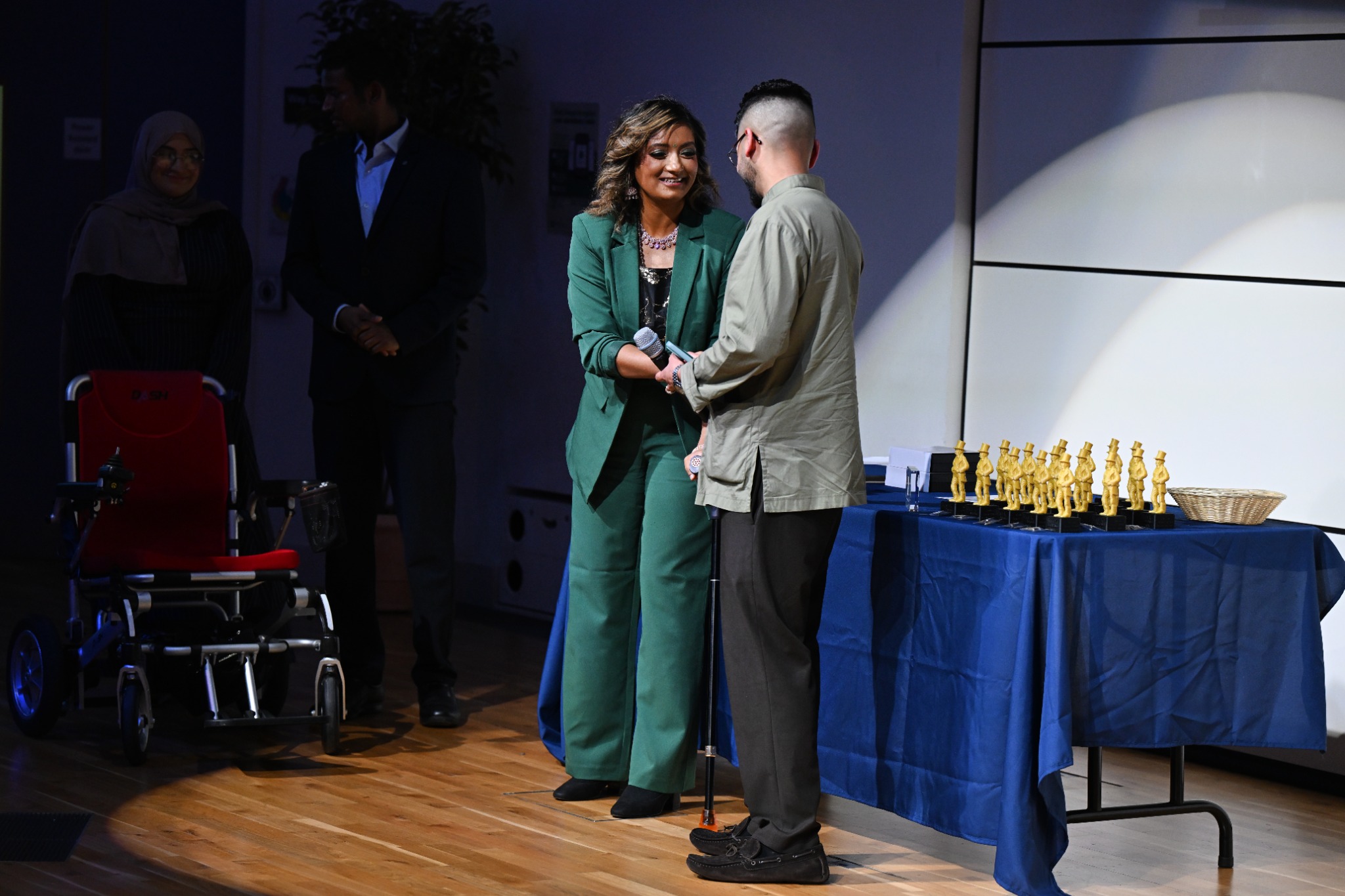 Asha receiving an award on stage